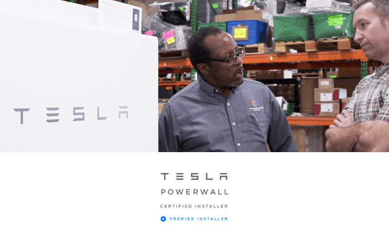 sun valley solar employee standing in front of tesla powerwall