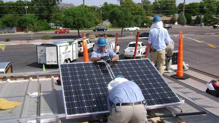 sun valley solar workers installing solar on top of nonprofit