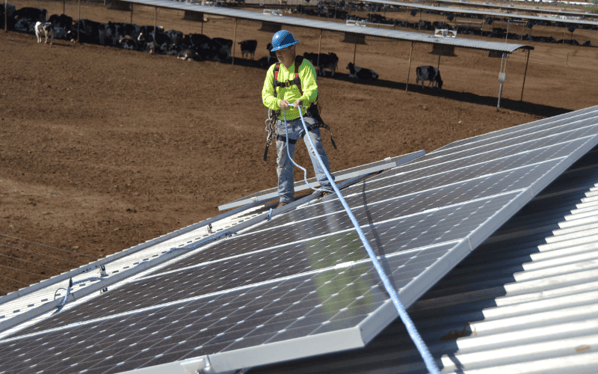 sun valley solar worker standing on roof with solar panels